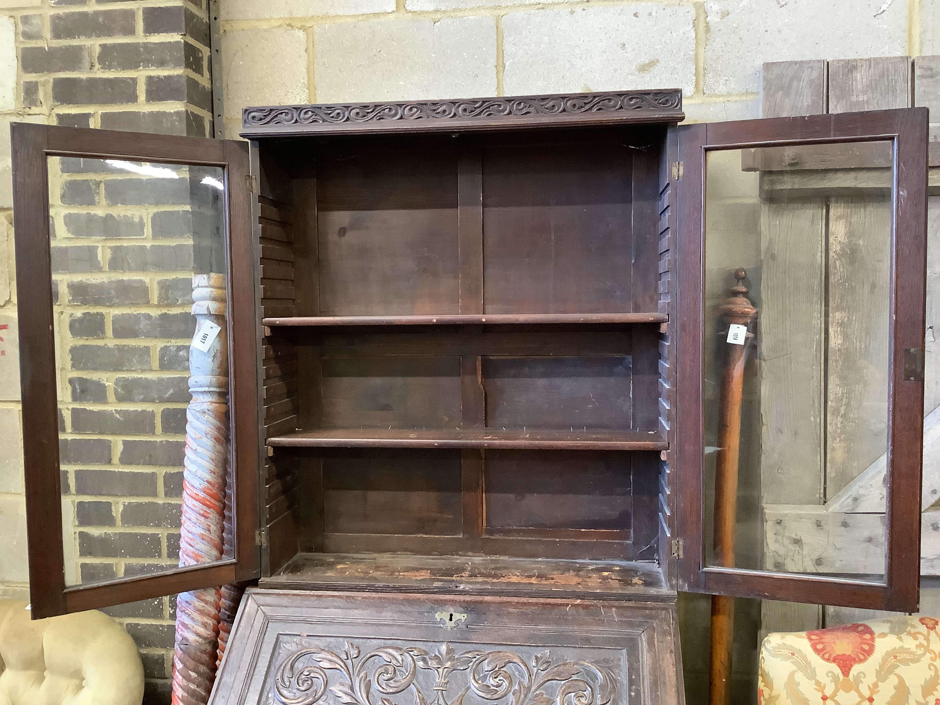 A Victorian carved oak bureau bookcase, width 94cm, depth 54cm, height 203cm